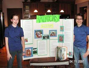 Tomtishen and Vorva with their science fair<br/> presentation on rainforests.